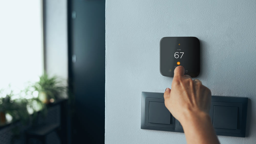 person using thermostat